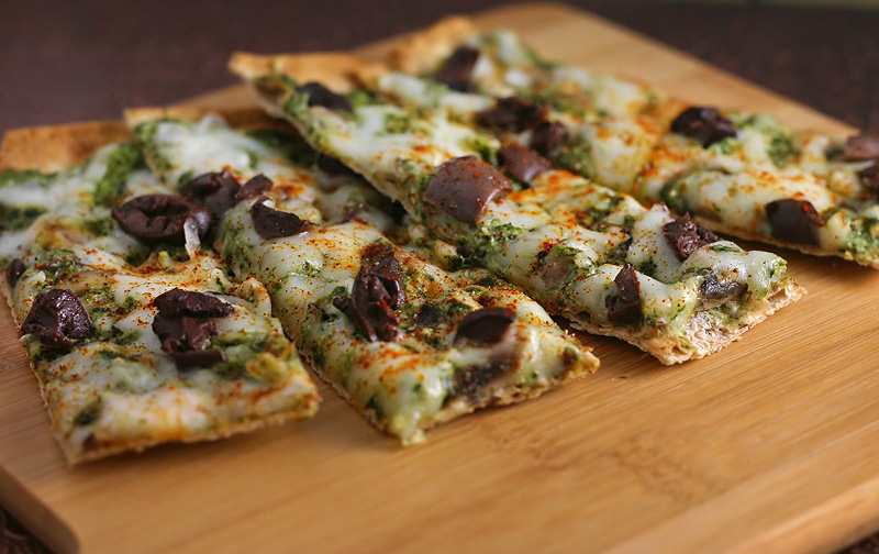 Low Calorie Flatbread Mushroom and spinach flatbread pieces on a cutting board